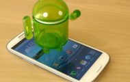 Android OS 5th Year - Samsung Phone With Android Tiny Mascot On Top - Droid Views