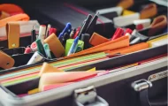 a portfolio filled with pens, stickie notes and documents
