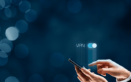 Man holding a phone with the words "VPN" hovering above.