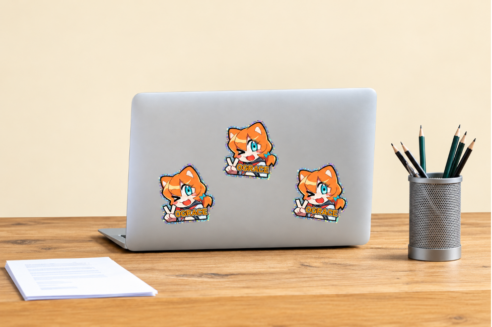 Silver laptop decorated with Vograce stickers.