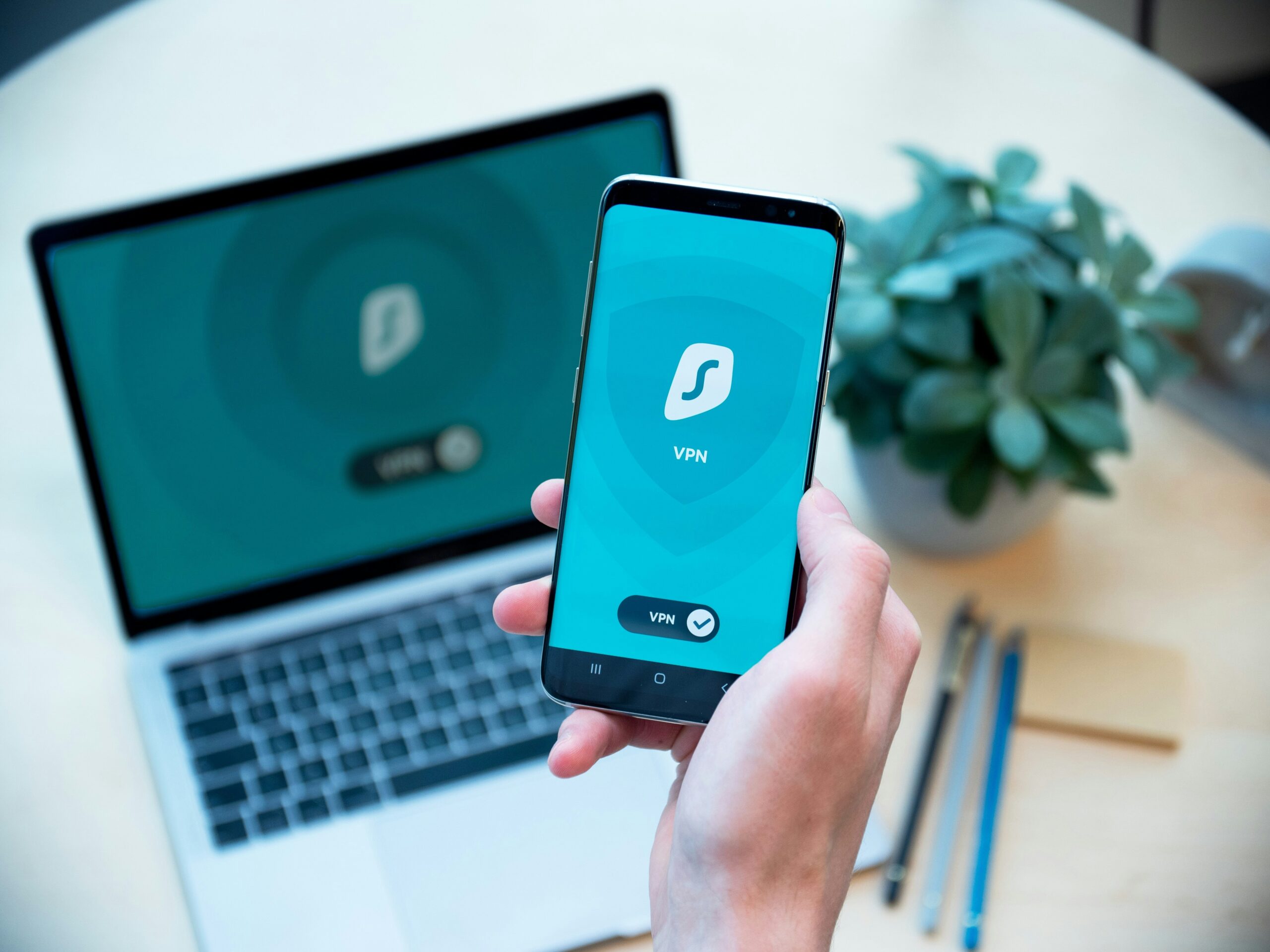 man holding a mobile phone with the word VPN on the screen.