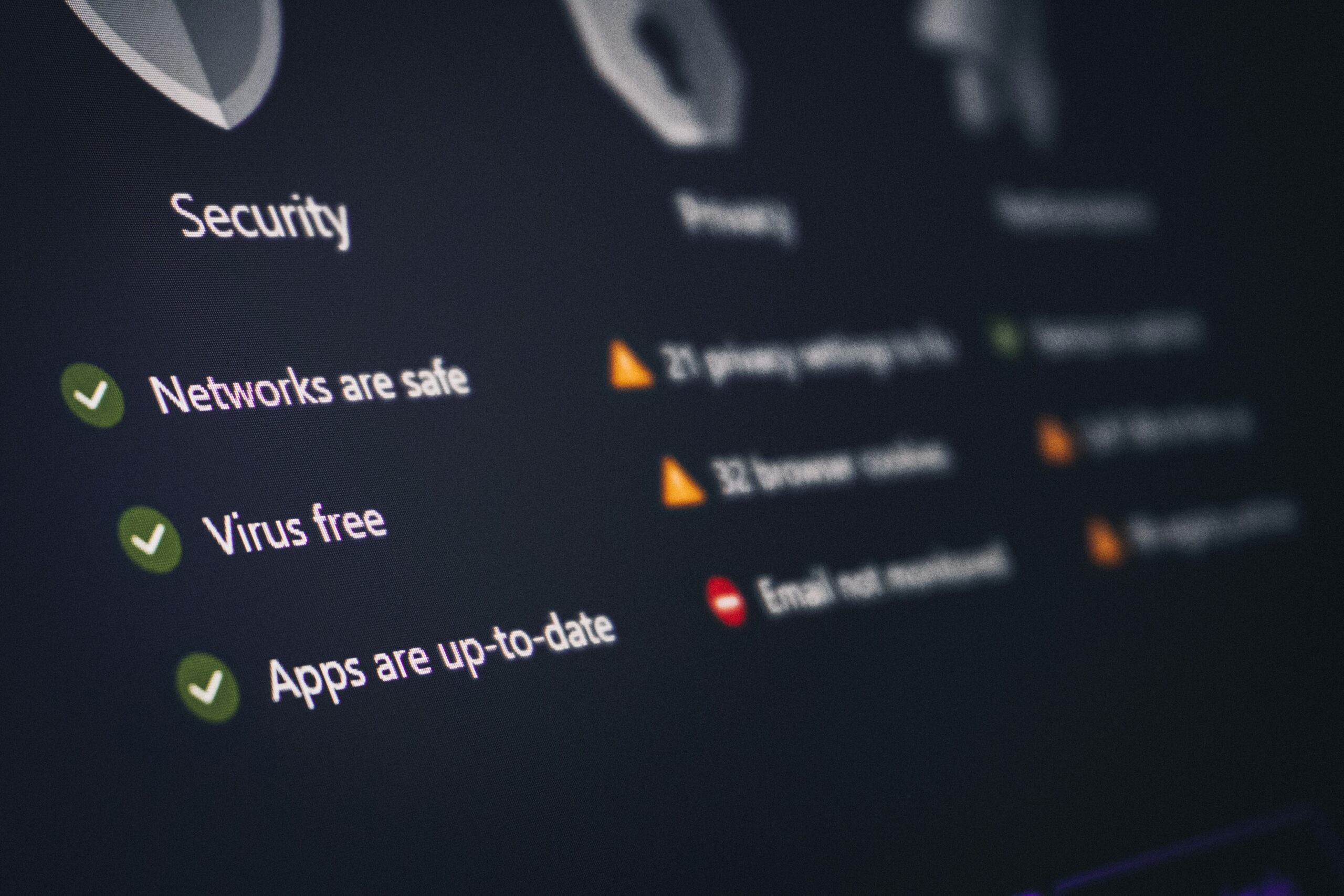 Computer security dashboard showing green checkmarks for network safety, virus protection, and updated apps.